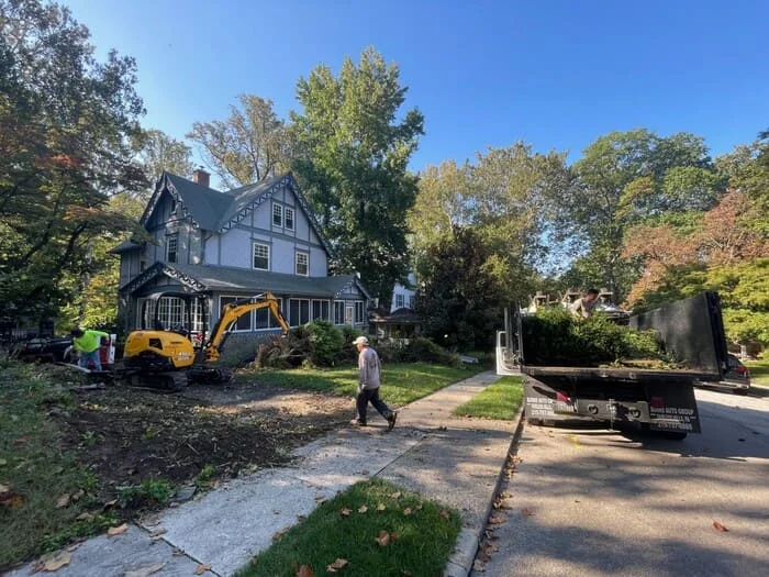 Residential drainage with subsurface drainage renovation, rain garden basin creation, native landscape design and install and boulder wall addition project in Lansdowne, PA