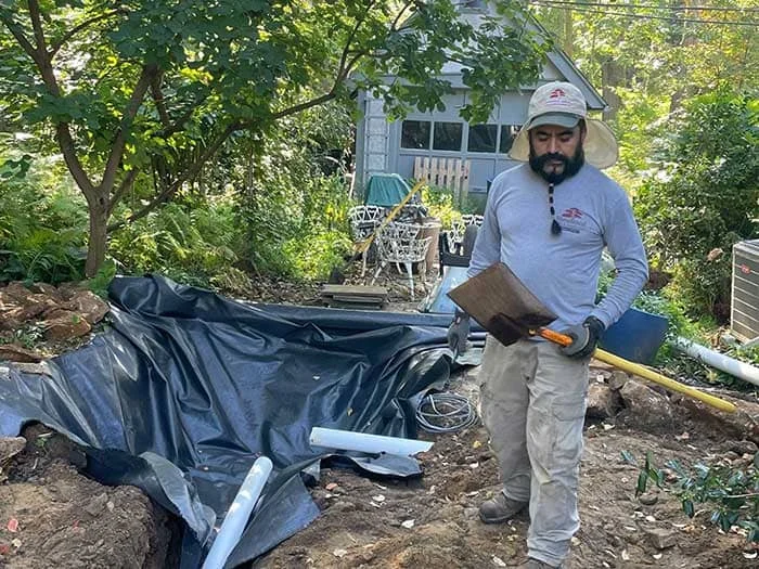 Residential drainage with subsurface drainage renovation, rain garden basin creation, native landscape design and install and boulder wall addition project in Lansdowne, PA